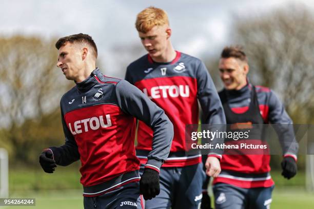 Tom Carroll, Sam Clucas and Connor Roberts in action during the Swansea City Training at The Fairwood Training Ground on May 02, 2018 in Swansea,...