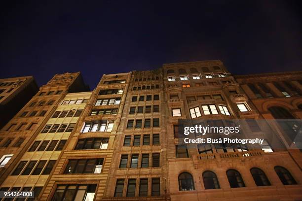 facades of pre-war highrise residential buildings in soho, manhattan, new york city, at night - ghaziabad police arrested a mastermind of a fake robbery of rs 16 lakh stockfoto's en -beelden