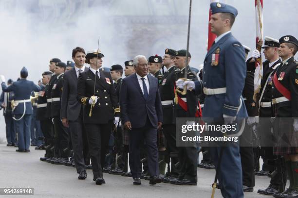 Antonio Costa, Portugal's prime minister, center, and Justin Trudeau, Canada's prime minister, inspect the military honour guard after arriving on...