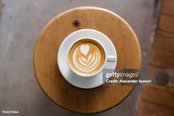 view of coffee cup with latte art straight from above - coffee heart fotografías e imágenes de stock