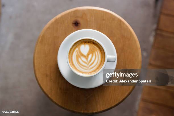 view of coffee cup with latte art straight from above - coffee heart stock pictures, royalty-free photos & images