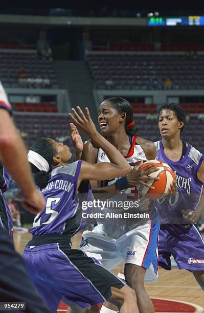 Swin Cash of the Detroit Shock is defended by Kedra Holland-Corn of the Sacramento Monarchs during the game on June 30, 2002 at the Palace of Auburn...