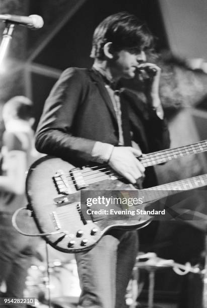 English singer-songwriter, musician and producer Nick Lowe on stage with a double neck guitar, UK, 28th October 1977.