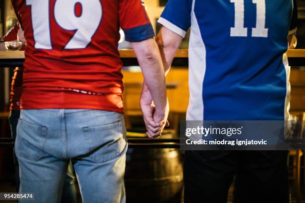gay men - man wearing sports jersey stock pictures, royalty-free photos & images