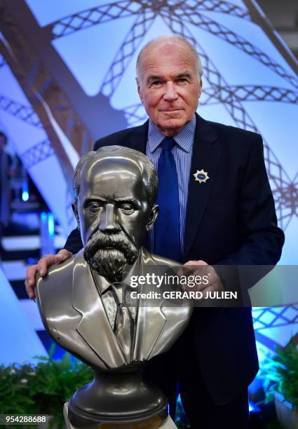 Rene-Georges Lavergne, president of the jury of the "Concours Lepine" poses next to the bust of Louis Lepine, during the 117th Lepine Contest, at...