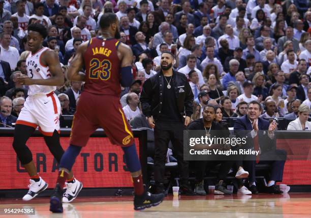 Singer Drake talks to LeBron James of the Cleveland Cavaliers from his court side seat in the first half of Game One of the Eastern Conference...