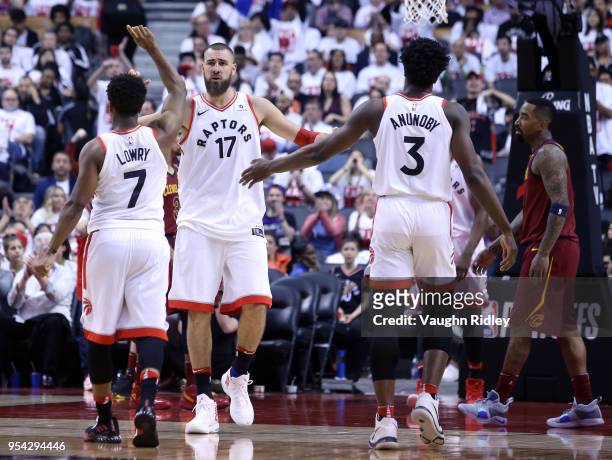 Jonas Valanciunas of the Toronto Raptors high fives Kyle Lowry and OG Anunoby in the second half of Game One of the Eastern Conference Semifinals...
