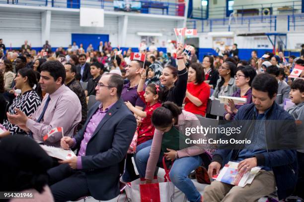 Aditi Pandit holds her daughter, Yashmak Pandit, during a citizenship ceremony held at the Royal Canadian Navy local reserve division HMCS York. 250...