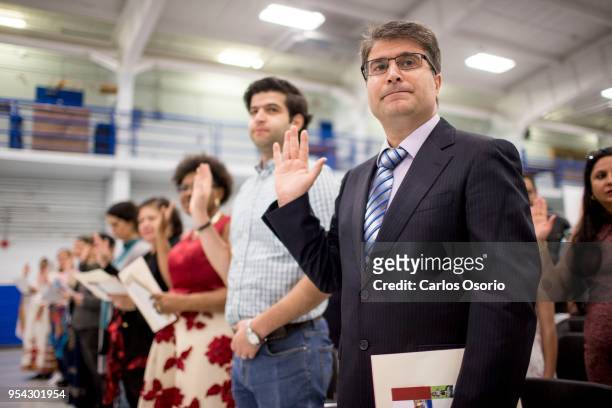 Hashem Emami, from Iran, takes the oath of citizenship during a citizenship ceremony held at the Royal Canadian Navy local reserve division HMCS...
