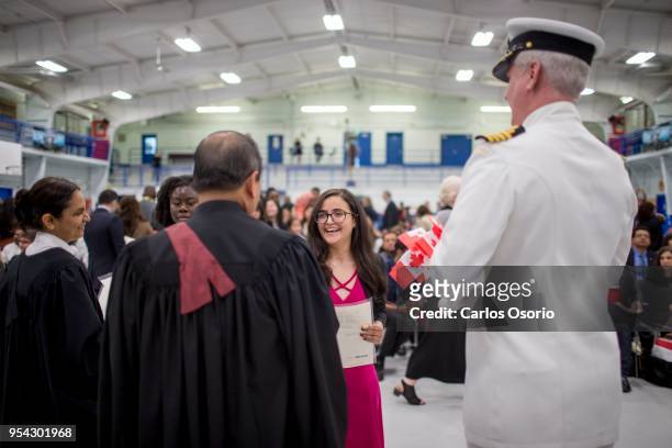 Rania Faidi, originally from Iran, receives a certificate during a citizenship ceremony held at the Royal Canadian Navy local reserve division HMCS...