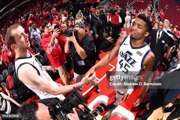 Joe Ingles and Donovan Mitchell of the Utah Jazz exchange a handshake after Game Two of Round Two of the 2018 NBA Playoffs against the Houston...