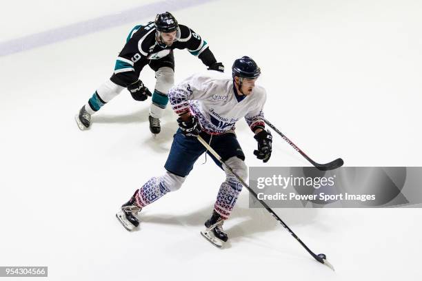 Luc Boby of Flying French fights for the puck with C. Toews of Cathay Flyers during the Mega Ice Hockey 5s match between Flying French and Cathay...
