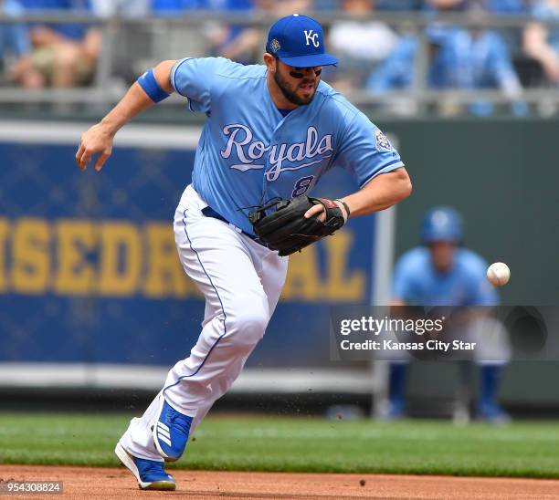 Kansas City Royals third baseman Mike Moustakas chases down a ground ball that bounced off his glove before throwing Detroit Tigers' Miguel Cabrera...