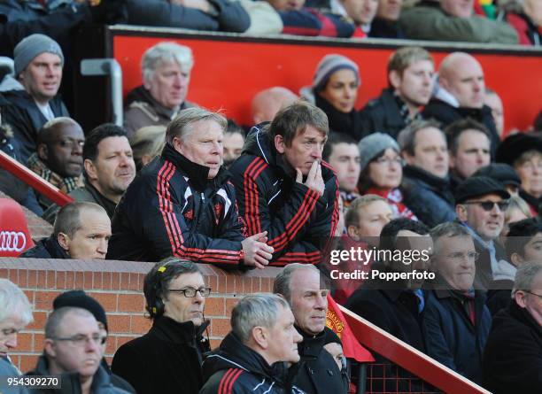 Liverpool manager Kenny Dalglish and assistant coach Sammy Lee watch from the crowd during the FA Cup sponsored by Eon 3rd round match between...