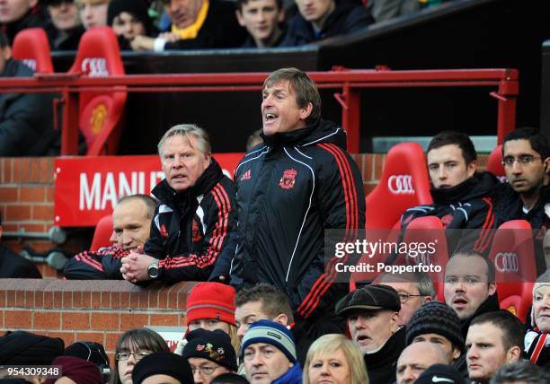 Liverpool manager Kenny Dalglish and assistant coach Sammy Lee watch from the crowd during the FA Cup sponsored by Eon 3rd round match between...