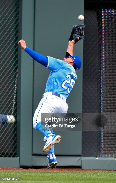 Ball hit by Jeimer Candelario of the Detroit Tigers bounces off the glove of Jon Jay of the Kansas City Royals in the third inning at Kauffman...