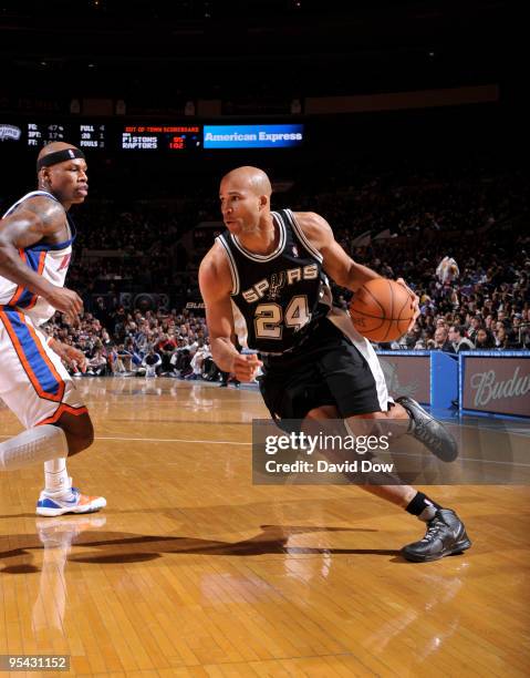 Richard Jefferson of the San Antonio Spurs drives against Al Harrington the New York Knicks on December 27, 2009 at Madison Square Garden in New York...