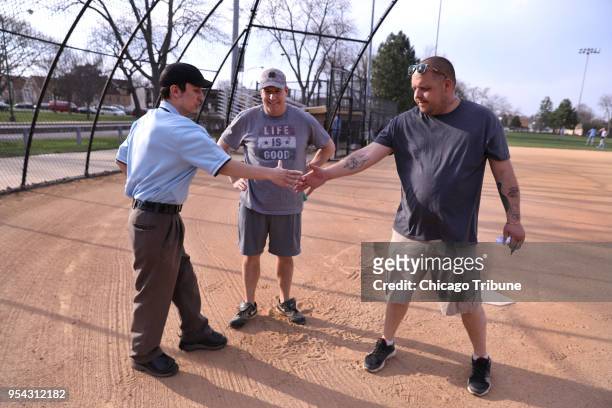 Umpire Kody O'Connor meets with coaches Tom Zimmermann and Harold Adams before the start of a 14U softball game on Tuesday, May 1, 2018 at Pioneer...