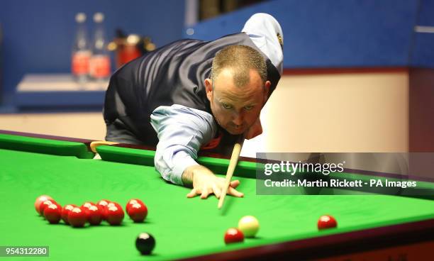 Mark Williams in action during his semi-final match against Barry Hawkins, on day thirteen of the 2018 Betfred World Championship at The Crucible,...