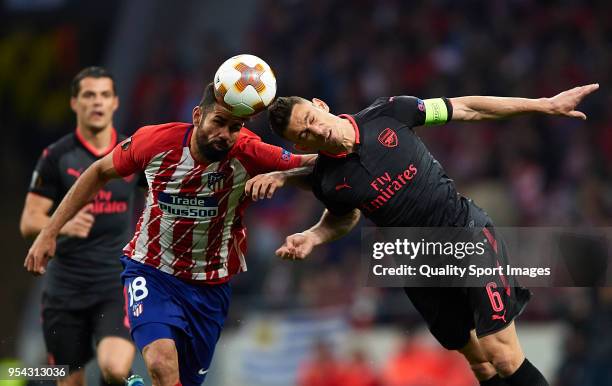 Diego Costa of Atletico de Madrid competes for the ball with Laurent Koscielny of Arsenal during the UEFA Europa League Semi Final second leg match...