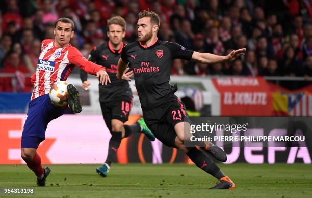 Atletico Madrid's French forward Antoine Griezmann vies with Arsenal's English defender Calum Chambers during the UEFA Europa League semi-final...