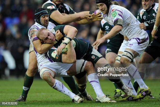 Matt Garvey of London Irish is brought down by Jonathan Thomas of Ospreys during the Heineken Cup Pool Three match between London Irish and Ospreys...