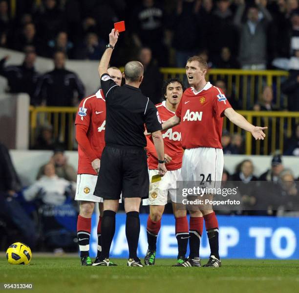 Darren Fletcher of Manchester United argues with referee Mike Dean after his teammate Rafael is given a red card during the Barclays Premier League...