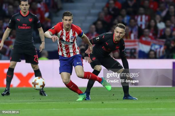 Gabi of Atletico Madrid and Laurent Koscielny of Arsenal battle for the ball during the UEFA Europa League Semi Final second leg match between...