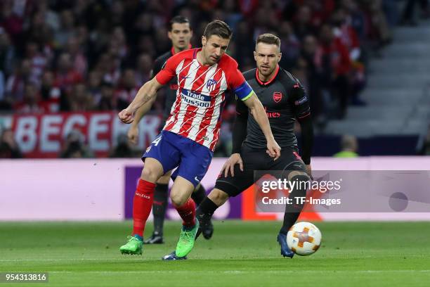 Gabi of Atletico Madrid and Laurent Koscielny of Arsenal battle for the ball during the UEFA Europa League Semi Final second leg match between...