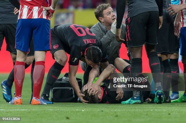 Laurent Koscielny of Arsenal lays injured on the ground during the UEFA Europa League Semi Final second leg match between Atletico Madrid and Arsenal...