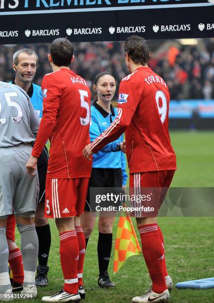 Liverpool's Daniel Agger and Fernando Torres shaking hands with referee Martin Atkinson and assistant referee Sian Massey ahead of the Barclays...