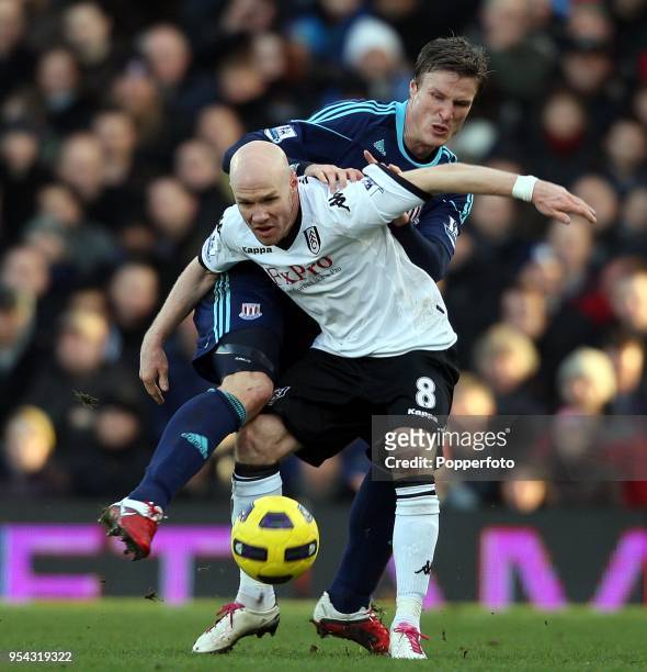 Andrew Johnson of Fulham battles with Robert Huth of Stoke City during the Barclays Premier League match between Fulham and Stoke City at Craven...