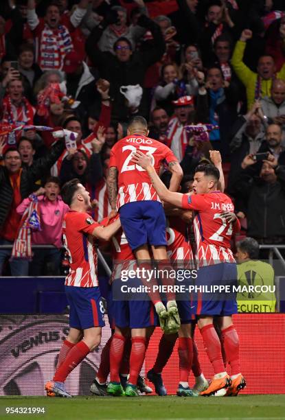 Atletico players celebrate the opening goal during the UEFA Europa League semi-final second leg football match between Club Atletico de Madrid and...