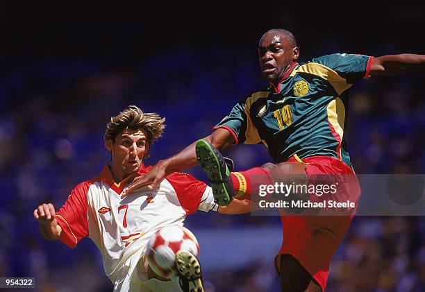 Angulo of Spain is challenged by Patrick Mboma of Cameroon during the Mens Football Final at the Olympic Stadium on Day 15 of the Sydney 2000 Olympic...