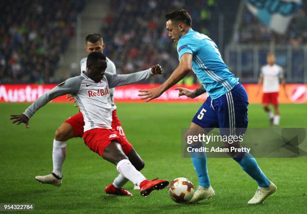 Lucas Ocampos of Marseille is tackled by Diadie Samassekou of Red Bull Salzburg during the UEFA Europa Semi Final Second leg match between FC Red...