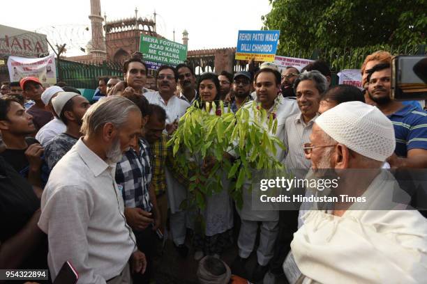 Alka Lamba and Asim Ahmed Khan along with others plant saplings after the anti-encroachment drive, at Jama Masjid on May 3, 2018 in New Delhi, India....