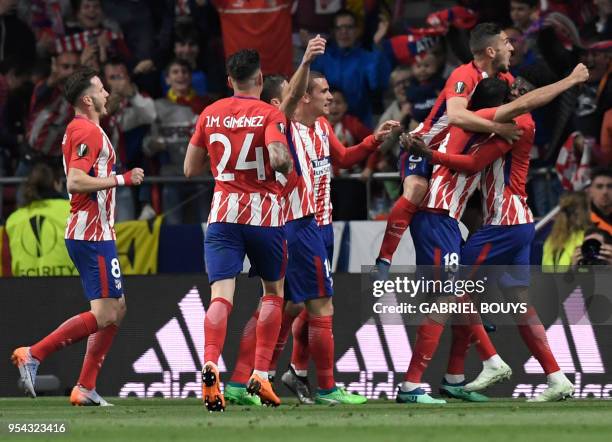 Atletico players celebrate the opening goal during the UEFA Europa League semi-final second leg football match between Club Atletico de Madrid and...