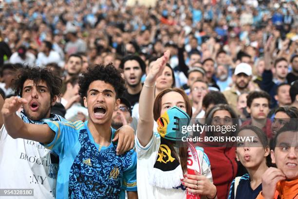 Olympique de Marseille fans react as they watch the Europa League semi-final football match Salzburg against Marseille on May 3, 2018 at the...