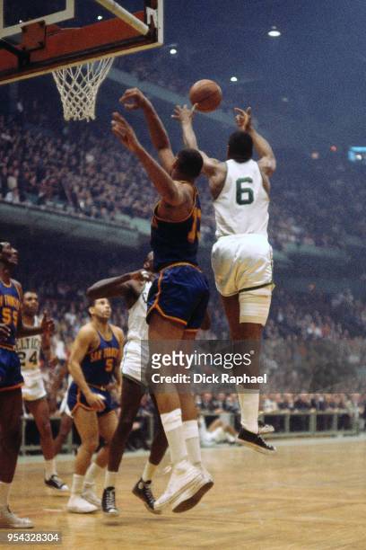 Bill Russell of the Boston Celtics and Wilt Chamberlain of the San Francisco Warriors go for a rebound circa 1964 at the Boston Garden in Boston,...