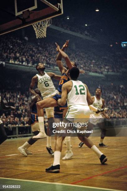 Bill Russell of the Boston Celtics and Wilt Chamberlain of the San Francisco Warriors go for a rebound circa 1964 at the Boston Garden in Boston,...