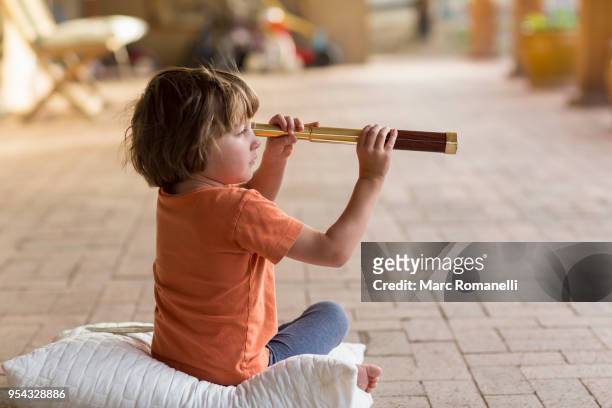 4 year old boy holding hand held telescope - lamy new mexico stock pictures, royalty-free photos & images
