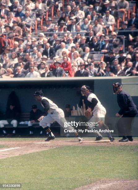 Roberto Clemente of the Pittsburgh Pirates swings at the pitch as catcher Ed Bailey of the San Francisco Giants and umpire Paul Pryor look on during...