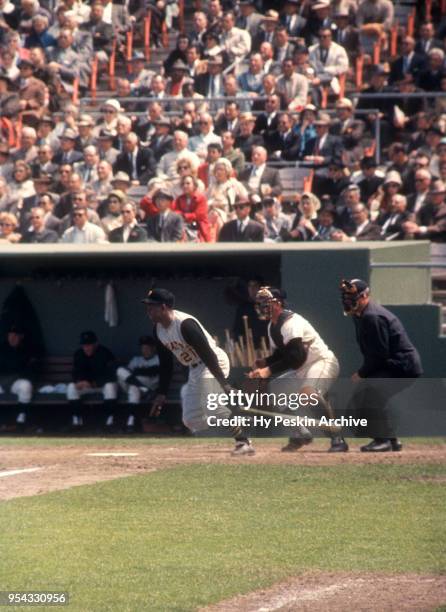 Roberto Clemente of the Pittsburgh Pirates swings at the pitch as catcher Ed Bailey of the San Francisco Giants and umpire Paul Pryor look on during...