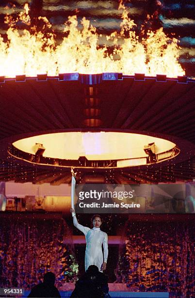 Cathy Freeman of Australia lights the Olympic Flame during the Opening Ceremony of the Sydney 2000 Olympic Games at the Olympic Stadium in Homebush...