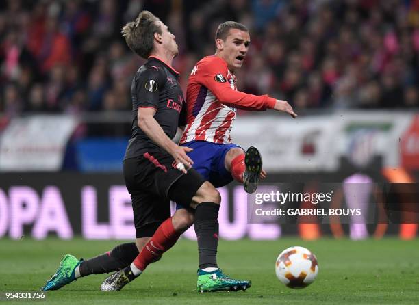 Arsenal's Spanish defender Nacho Monreal vies with Atletico Madrid's French forward Antoine Griezmann during the UEFA Europa League semi-final second...