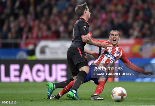 Arsenal's Spanish defender Nacho Monreal vies with Atletico Madrid's French forward Antoine Griezmann during the UEFA Europa League semi-final second...