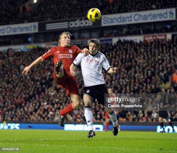 Dirk Kuyt of Liverpool battles with Chris Baird of Fulham during the Barclays Premier League match between Liverpool and Fulham at Anfield on January...