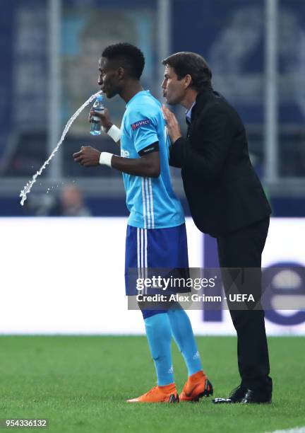 Rudi Garcia, head coach of Marseillespeak with Bouna Sarr of Marseille during the UEFA Europa Semi Final Second leg match between FC Red Bull...