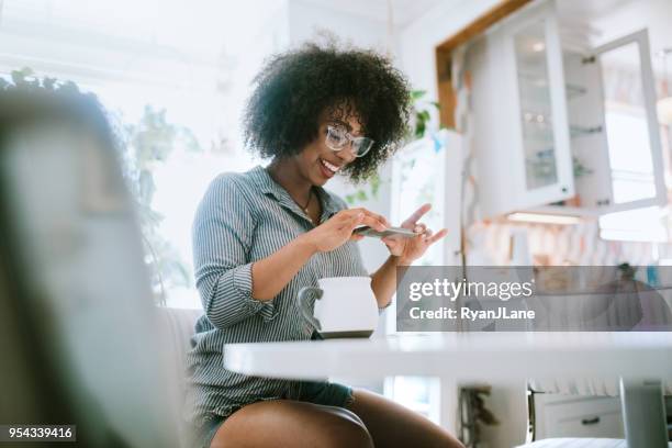 a young woman does remote deposit capture of check - deposit slip stock pictures, royalty-free photos & images