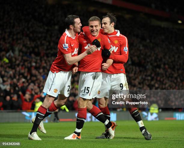 Nemanja Vidic of Manchester United celebrates with his team mates John O'Shea and Dimitar Berbatov after scoring a goal during the Barclays Premier...